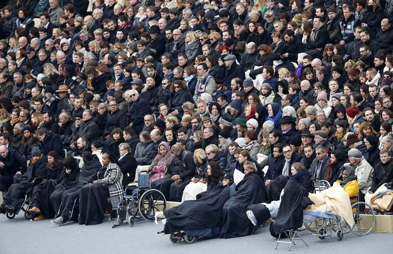 Wounded people in the Nov. 13 Paris attacks wait for the start of a ceremony in the courtyard of the Invalides in Paris, Friday, Nov. 27, 2015.