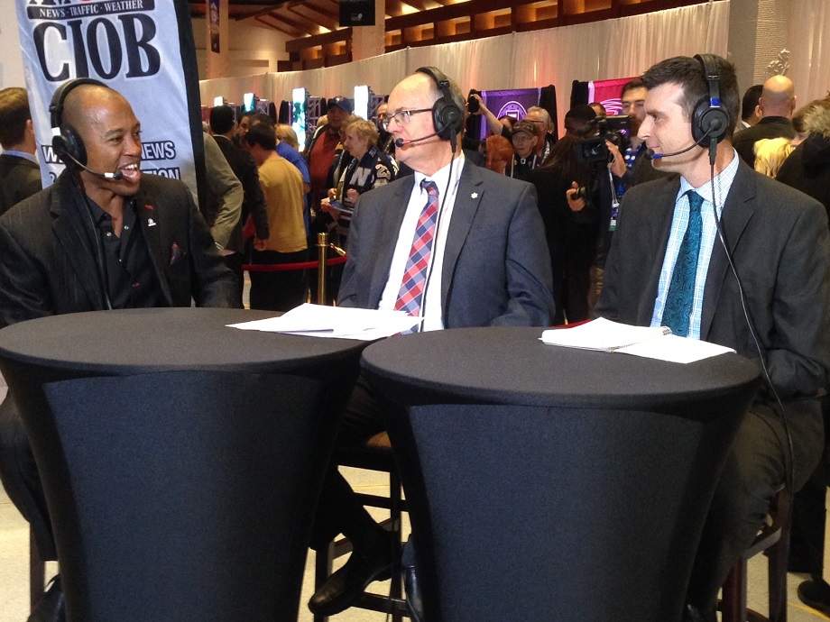 CFL Henry Burris, 680 CJOB’s Bob Irving and Global’s Russ Hobson laugh during the Shaw CFL Player Awards pre-show in 2015.