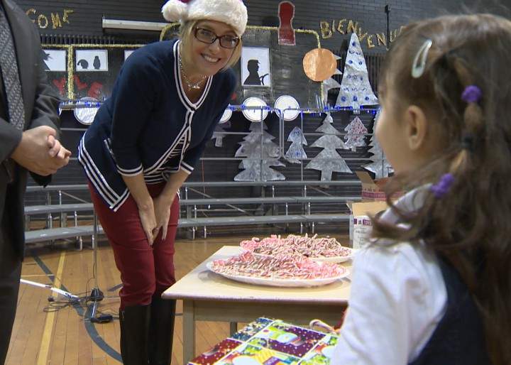 Global Montreal's Senior Anchor Jamie Orchard greets a child at the Generations' Holiday Food and Toy Drive.