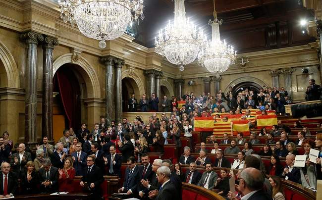 Popular Party of Catalonia, right, show Spanish flags and Catalonia flags at the end of a parliamentary session at the Parliament in Barcelona, Spain, Monday, Nov. 9, 2015. 