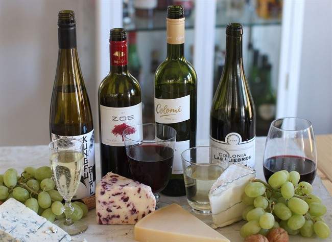 This Oct. 19, 2015 photo, shows four wines for under $15, from left to right, "Kungfu Girl," a Columbia Valley Riesling from Washington state, “Zoe” Red Peloponnese, from Greece, Colome, from Argentina, and Colonia, also from Argentina, in Concord, NH.