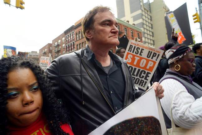 In this Oct. 24, 2015 file photo, director Quentin Tarantino, center, participates in a rally to protest against police brutality in New York.