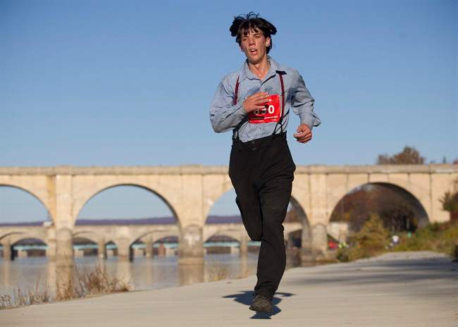 In this photo taken on Sunday, Nov. 8, 2015, Leroy Stolzfus, of Gordonville runs in the 2015 Harrisburg Marathon in Harrisburg, Pa.