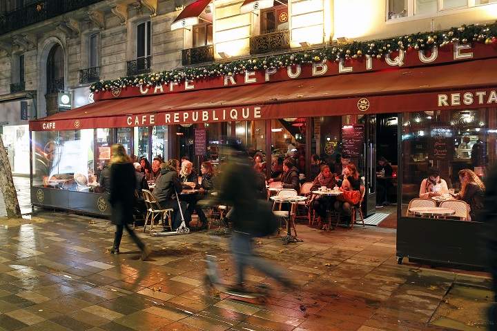 People sit outside a restaurant in the 11th district of Paris one week after a series of terrorist attacks on November 20, 2015 in Paris, France.