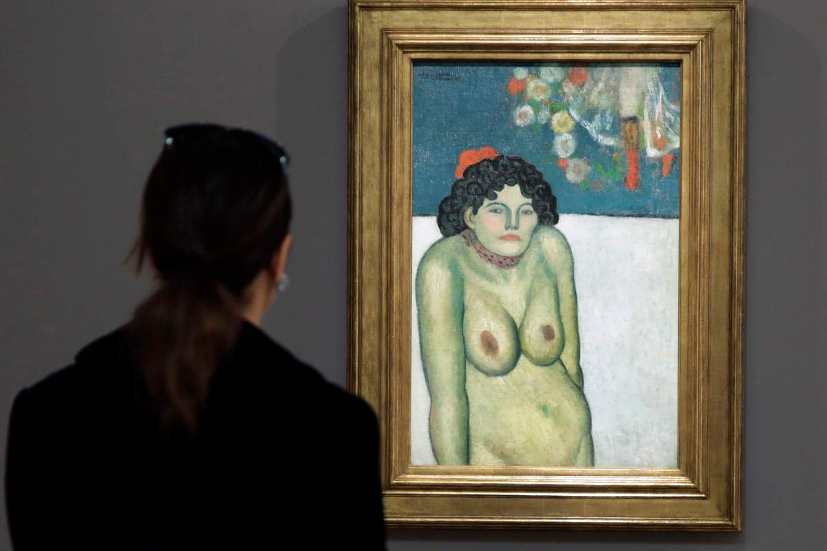 This Oct. 30, 2015 file photo shows "The Nightclub Singer,” a 1901 painting by Picasso from his Blue Period, at Sotheby's in New York. The work features a second picture on the reverse side depicting Picasso’s art dealer, Pere Manach. 