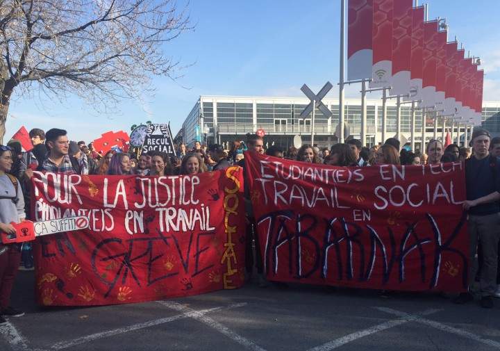 Students hold us signs during an austerity protest in Montreal's Old Port, Thursday, November 5, 2015.