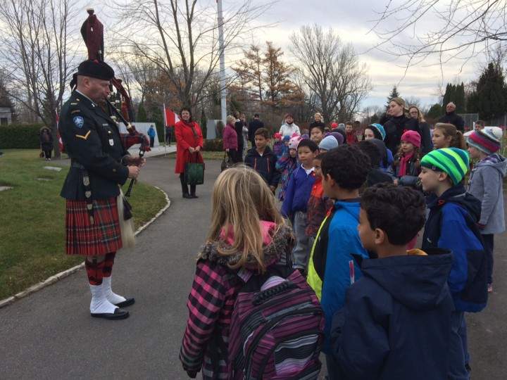 School children gather to pay their respects to Canada's soldiers, Tuesday, November 11, 2015.