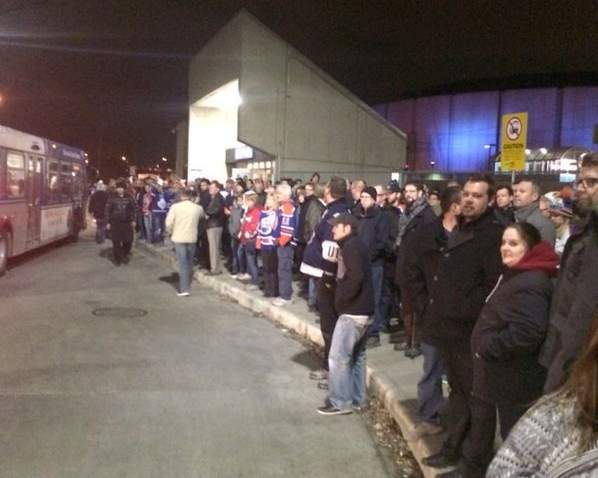 Hockey fans wait for buses outside Rexall Place Wednesday, Nov. 18, 2015 after a portion of the LRT line went down.