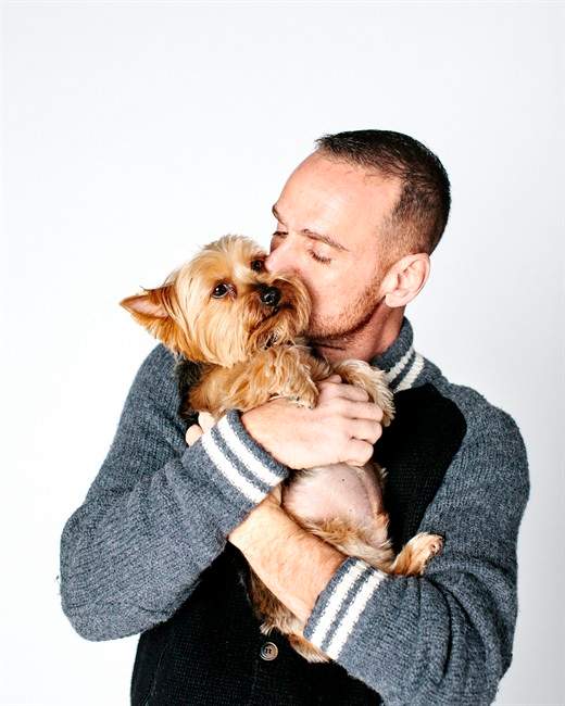 Dr. Rob Garofalo poses for a portrait with his dog, a Yorkshire terrier named Fred, in Chicago. The portrait is part of the "When Dogs Heal" project, a photo exhibit of HIV-positive people and their dogs that opens Dec. 1 in Chicago and Dec. 3 in New York City.