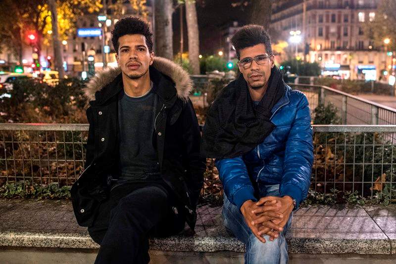In this photo taken on Sunday, Nov. 15, 2015, Khaled Saadi, 27, left and Abdullah Saadi, 38, listen during an interview with the Associated Press.
