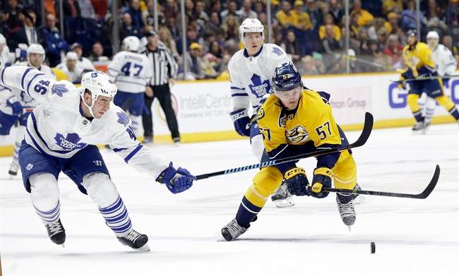 Toronto Maple Leafs defenseman Roman Polak (46) and Nashville Predators left wing Gabriel Bourque (57) chase the puck in the second period of an NHL hockey game Thursday, Nov. 12, 2015, in Nashville, Tenn.
