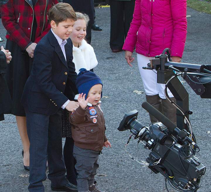 Prime Minister-designate Justin Trudeau’s children Xavier, Ella-Grace and Hadrian (right to left) wave to a television camera as they wait for their parents to arrive at Rideau Hall in Ottawa, November 4, 2015.