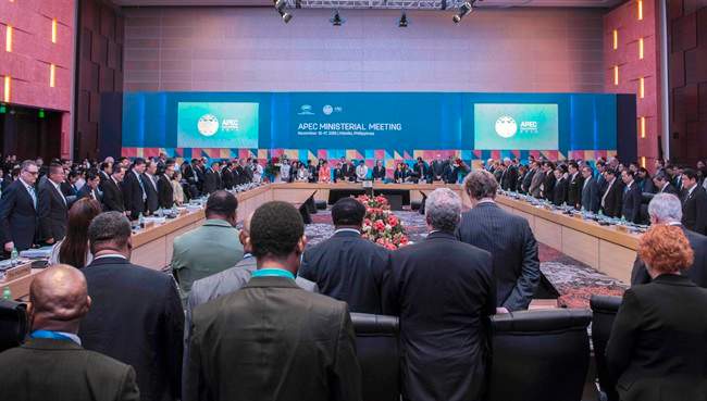 Officials have a moment of silence for those who were involved in deadly attacks in Paris, during the Asia-Pacific Economic Cooperation (APEC) Ministerial Meeting in Manila, Philippines, Monday, Nov. 16, 2015. (Lui Wai Siu/Pool Photo via AP).