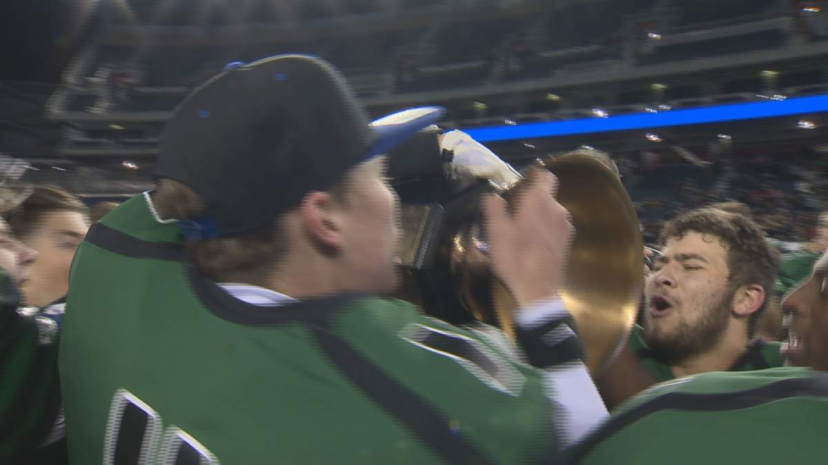 The Vincent Massey Trojans celebrate with the ANAVETS Bowl Trophy.