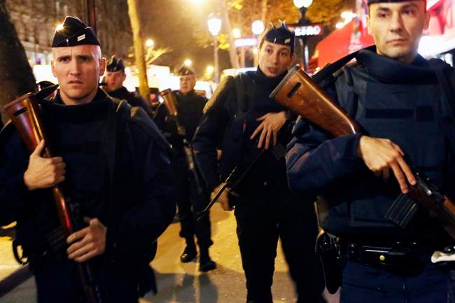 French police patrol at the place de la Republique in Paris, France, Sunday Nov. 15, 2015.