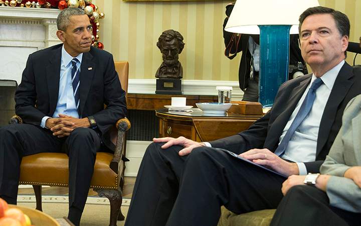 President Barack Obama sits with FBI director James Comey in the Oval Office of the White House in Washington, on Dec. 3, 2015.
