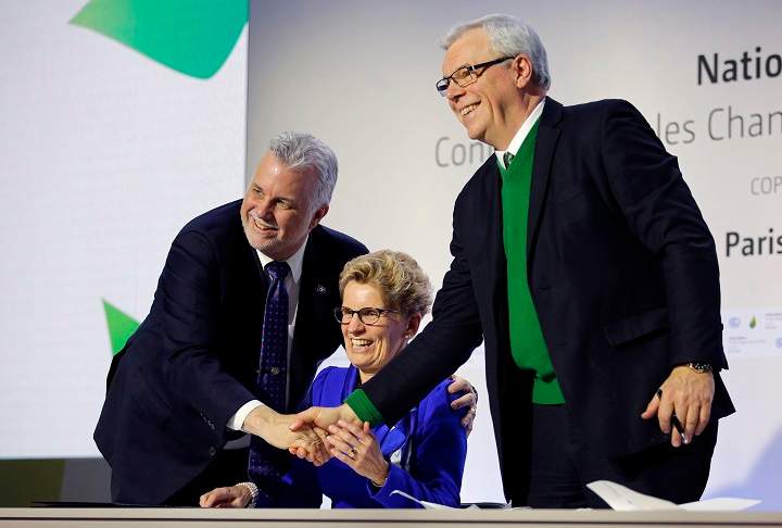 Quebec Premier Philippe Couillard, left, Ontario Premier Kathleen Wynne, center, and Manitoba Premier Greg Selinger shake hands during a signing ceremony at the COP21, the United Nations Climate Change Conference Monday, Dec. 7, 2015 in Le Bourget, north of Paris. The Paris conference is the 21st time world governments are meeting to seek a joint solution to climate change. The talks are focused on reducing emissions of carbon dioxide and other greenhouse gases, primarily by shifting from oil, coal and gas to cleaner sources of energy. (AP Photo/Christophe Ena).