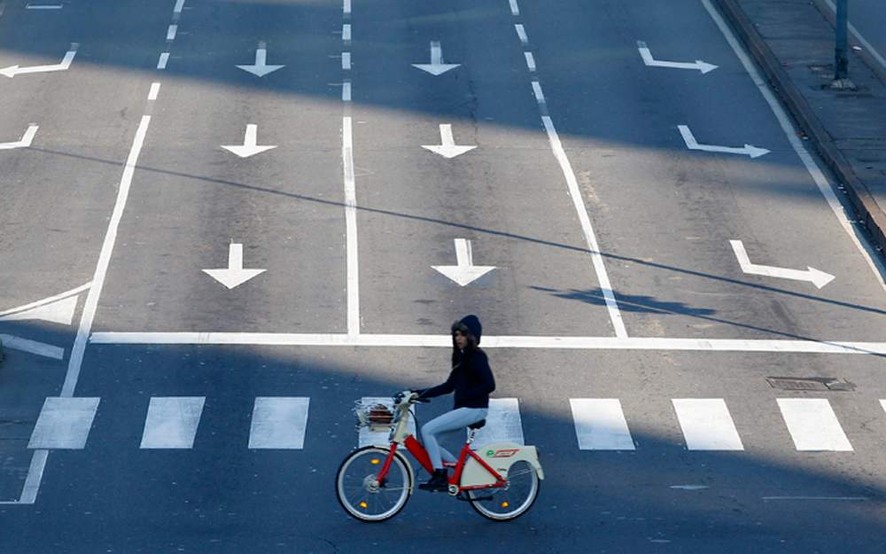 A cyclist pedals in downtown Milan, Italy, Monday, Dec. 28, 2015.  Milan has ordered Monday a no-car day to combat pollution, which has hit unhealthy levels for weeks mainly because no rain has fallen to wash away the smog. 