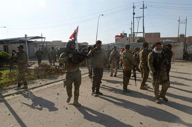 Iraqi security forces enter the government complex in central Ramadi, 70 miles (115 kilometers) west of Baghdad, Iraq, Monday, Dec. 28, 2015.