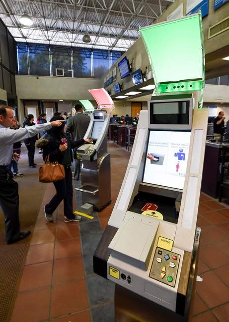 Pedestrians crossing from Mexico into the United States at the Otay Mesa Port of Entry wait to use at a biometric kiosks Thursday, Dec. 10, 2015, in San Diego. On Thursday, U.S. Customs and Border Protection began capturing facial and eye scans of foreigners entering the country at San Diego's Otay Mesa port of entry on foot. (AP Photo/Denis Poroy).