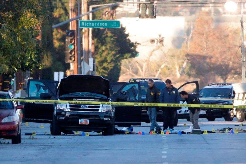 Authorities investigate the scene where a police shootout with suspects took place, Thursday, Dec. 3, 2015, in San Bernardino, Calif.