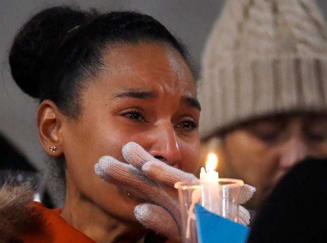 A woman cries during a vigil for shooting victims at San Manuel Stadium, Thursday, Dec. 3, 2015, in San Bernardino, Calif. A husband and wife opened fire on a holiday banquet, killing multiple people on Wednesday. Hours later, the couple died in a shootout with police. (AP Photo/Mark J. Terrill)