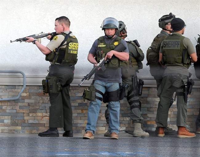 Authorities search a residential area following a shooting that killed multiple people at a social services center for the disabled on Wednesday, Dec. 2, 2015, in San Bernardino, Calif. (James Quigg/The Victor Valley Daily Press via AP) MANDATORY CREDIT