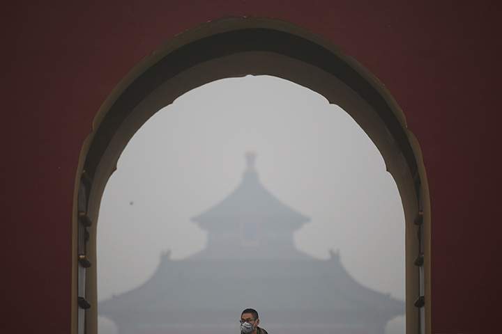 A man wearing mask visits Temple of Heaven Park during a day of heavy pollution on December 9, 2015 in Beijing, China.