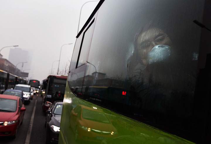 A man wears a mask to protect against pollution while commuting to work in heavy smog on December 8, 2015 in Beijing, China.