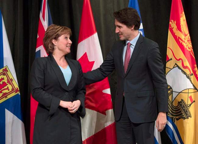 Prime Minister Justin Trudeau speaks with B.C. Premier Christy Clark as he officially welcomes her to the First Ministers meeting at the Museum of Nature, in Ottawa, on November 23, 2015. 