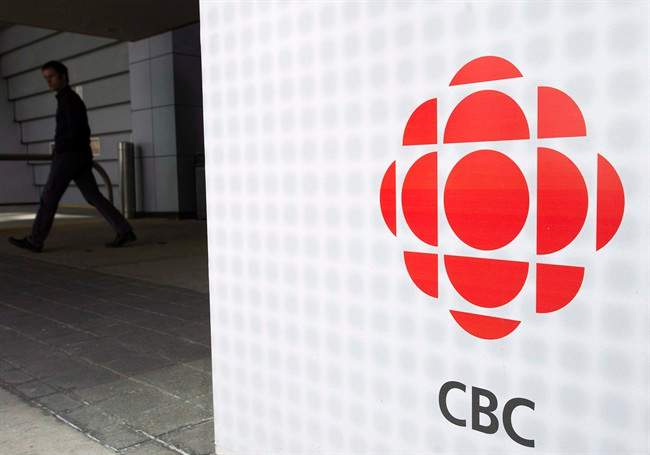 A man leaves the CBC building, in Toronto, on April 4, 2012. It's been a heck of a year for the CBC ??? a scathing report denounced managers for their handling of the Jian Ghomeshi affair while former anchors Amanda Lang and Evan Solomon faced controversies of their own, not to mention steep budget cuts that slashed news broadcasts, gutted sports and documentary divisions and put for sale signs in front of aging facilities. THE CANADIAN PRESS/Nathan Denette.