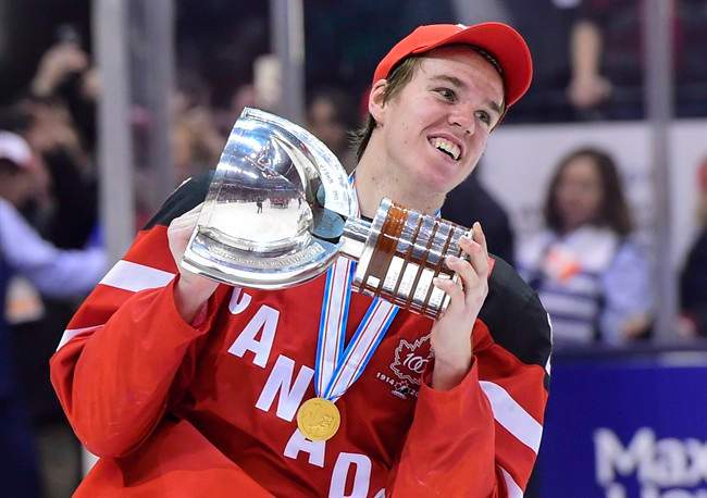 Canada’s Connor McDavid skates with the trophy following his team’s gold medal victory over Team Russia at the IIHF World Junior Championship in Toronto on Jan. 5, 2015.