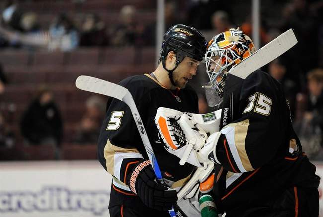 Anaheim Ducks defenseman Steve Montador (5) and Anaheim Ducks goalie Jean-Sebastien Giguere (35) knock helmets after beating the Colorado Avalanche in an NHL hockey game on Nov. 24, 2008 in Anaheim, Calif.