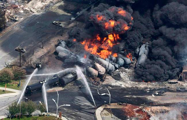 Smoke rises from railway cars that were carrying crude oil after derailing in Lac Megantic, Que., July 6, 2013.