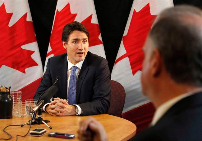 Prime Minister Justin Trudeau speaks with reporters during an interview with The Canadian Press in Ottawa on Wednesday, December 16, 2015. Ensuring Canadians have access to federal information will mean more â€” and sometimes difficult â€” public scrutiny, but ultimately it will lead to better government, the prime minister says. 