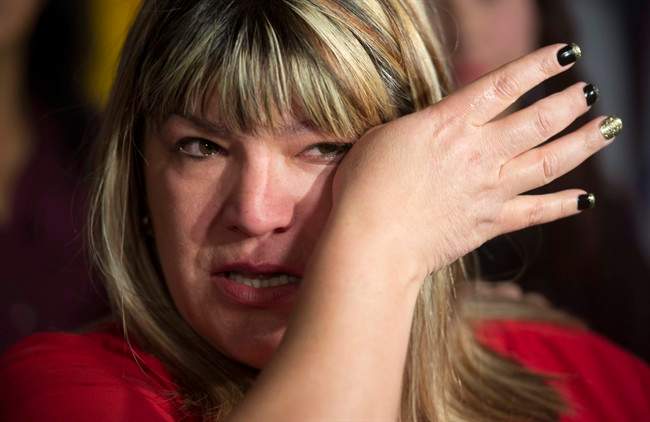 Bernadette Smith, from Winnipeg, wipes away tears as she talks about the Missing and Murdered Indigineous Women inquiry Tuesday December 8, 2015 on Parliament Hill in Ottawa. THE CANADIAN PRESS/Adrian Wyld.