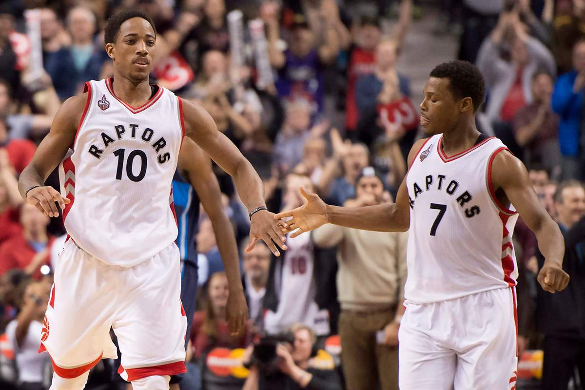 Toronto Raptors guards DeMar DeRozan (left) and Kyle Lowry congratulate each other in the dying seconds of a 103-99 win over the Dallas Mavericks.