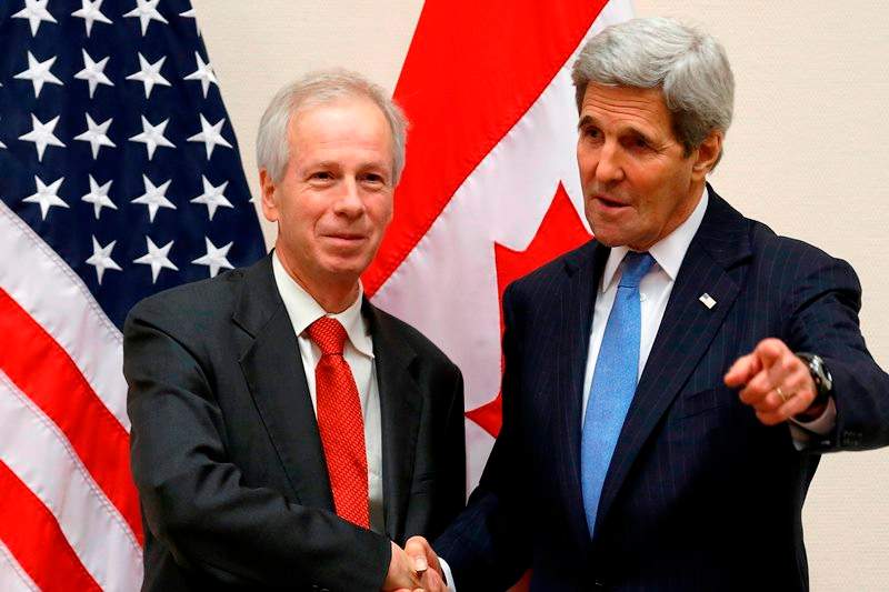 Canadian Foreign Minister Stephane Dion, left, meets with U.S. Secretary of State John Kerry alongside NATO ministerial meetings at NATO Headquarters in Brussels, Tuesday, Dec. 1, 2015.