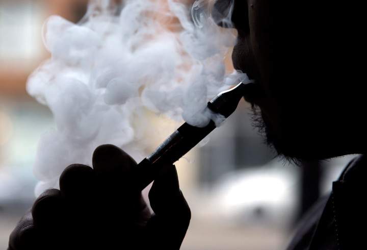 A man smokes an e-cigarette