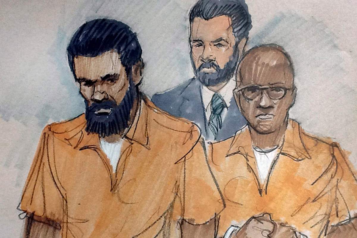 In this courtroom sketch, Jonas M. Edmonds, left, and Hasan R. Edmonds, right, stand in front of an FBI agent as they appear at a hearing at federal court in Chicago, Thursday, March 26, 2015,.