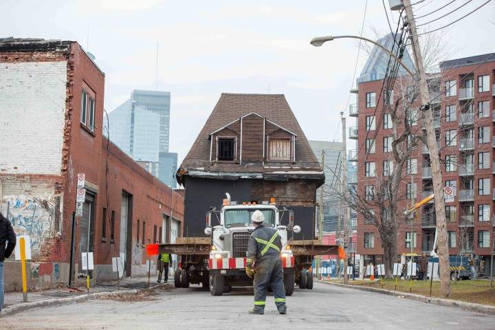 A worker looks on as la Maison Keegan is moved 300 metres to its temporary location on Rioux Street, Montreal, December 9, 2015.