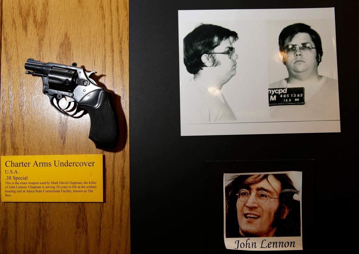 The gun used by Mark David Chapman to kill John Lennon, a Charter Arms .38-caliber pistol, is displayed next to their pictures at a small museum in the Forensic Investigation Division of the New York Police Department in New York, Tuesday, Dec. 8, 2015. Today is the anniversary of Lennon’s death; he was killed 35 years ago by Chapman in New York. (AP Photo/Seth Wenig)