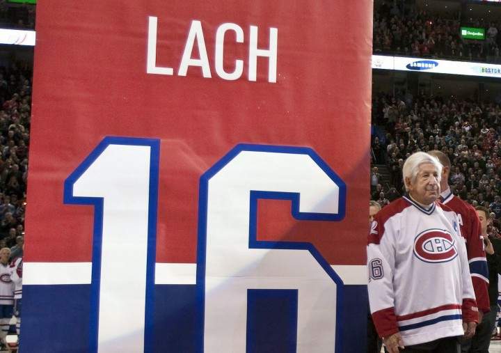 Former Montreal Canadiens Elmer Lach waits as a banners with his number is to be raised during a retirement ceremony before an NHL hockey game in Montreal.