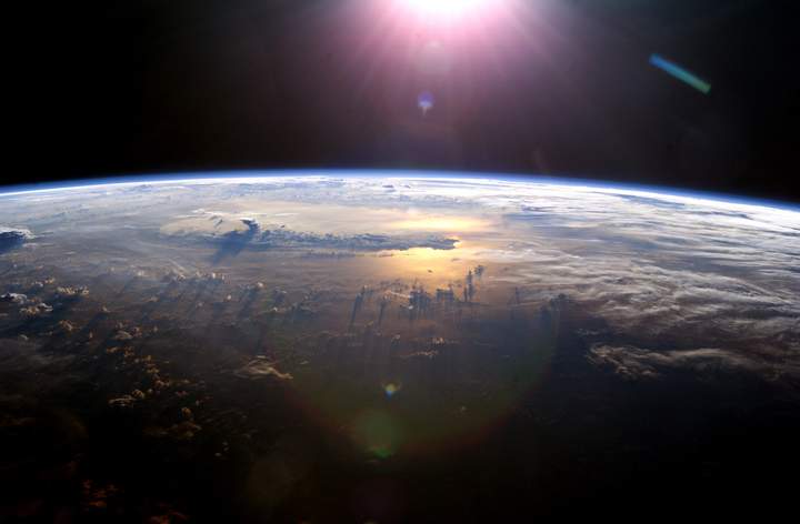 The sun illuminates Earth as seen from the International Space Station.