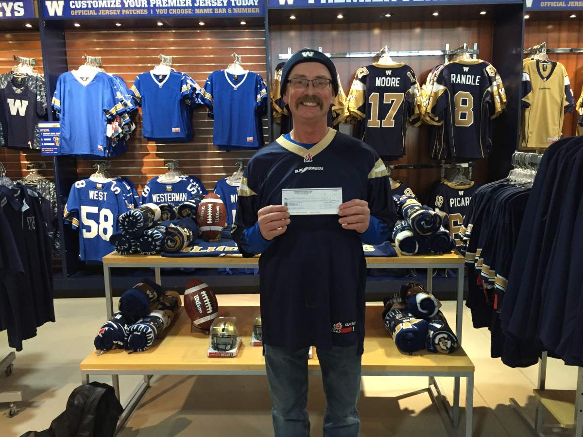 Charles Ritchot holds his nearly $180K raffle ticket after number mix-up almost saw him throw the ticket out.