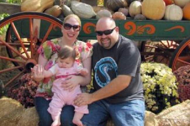 San Bernardino victim Robert Adams is seen with his wife and young daughter.
