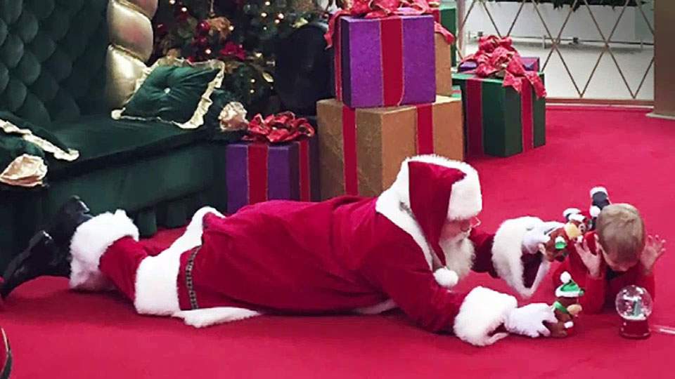 ‘Tis the season of understanding: why Santa Claus took a photo with a young boy on the floor - image