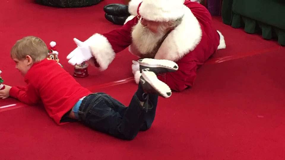 ‘Tis the season of understanding: why Santa Claus took a photo with a young boy on the floor - image
