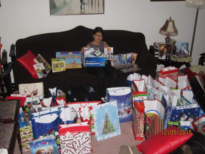 Talar Tejirian sits in front of 50 gifts she bought for boys and girls at Ste. Justine’s Hospital.