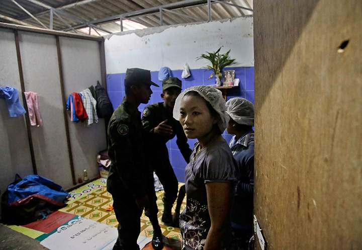 In this Monday, Nov. 9, 2015 photo, Thai soldiers search a room at the workers’ living quarters during a raid on a shrimp shed in Samut Sakhon, Thailand.